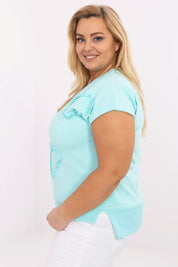 Model wearing Arlenna Plus Size Sweetheart Blouse in turquoise, showcasing the flattering sweetheart neckline and short sleeves.