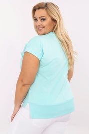 Woman wearing Arlenna Plus Size Sweetheart Blouse in aqua blue, viewed from the back, showcasing its fit and short sleeves.