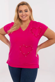 Woman wearing Arlenna Plus Size Sweetheart Blouse in pink, featuring heart designs. Ideal for casual or office wear. Comfortable fit.