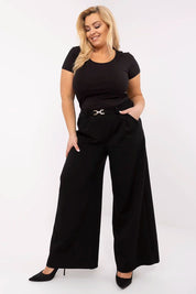 Woman wearing Elvarra Plus Size Cotton Tee paired with wide-leg black trousers, showcasing effortless style and comfort.