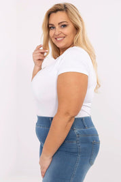 Plus size model wearing the Elvarra Plus Size Cotton Tee with short sleeves and round neckline, ideal for casual outfits.