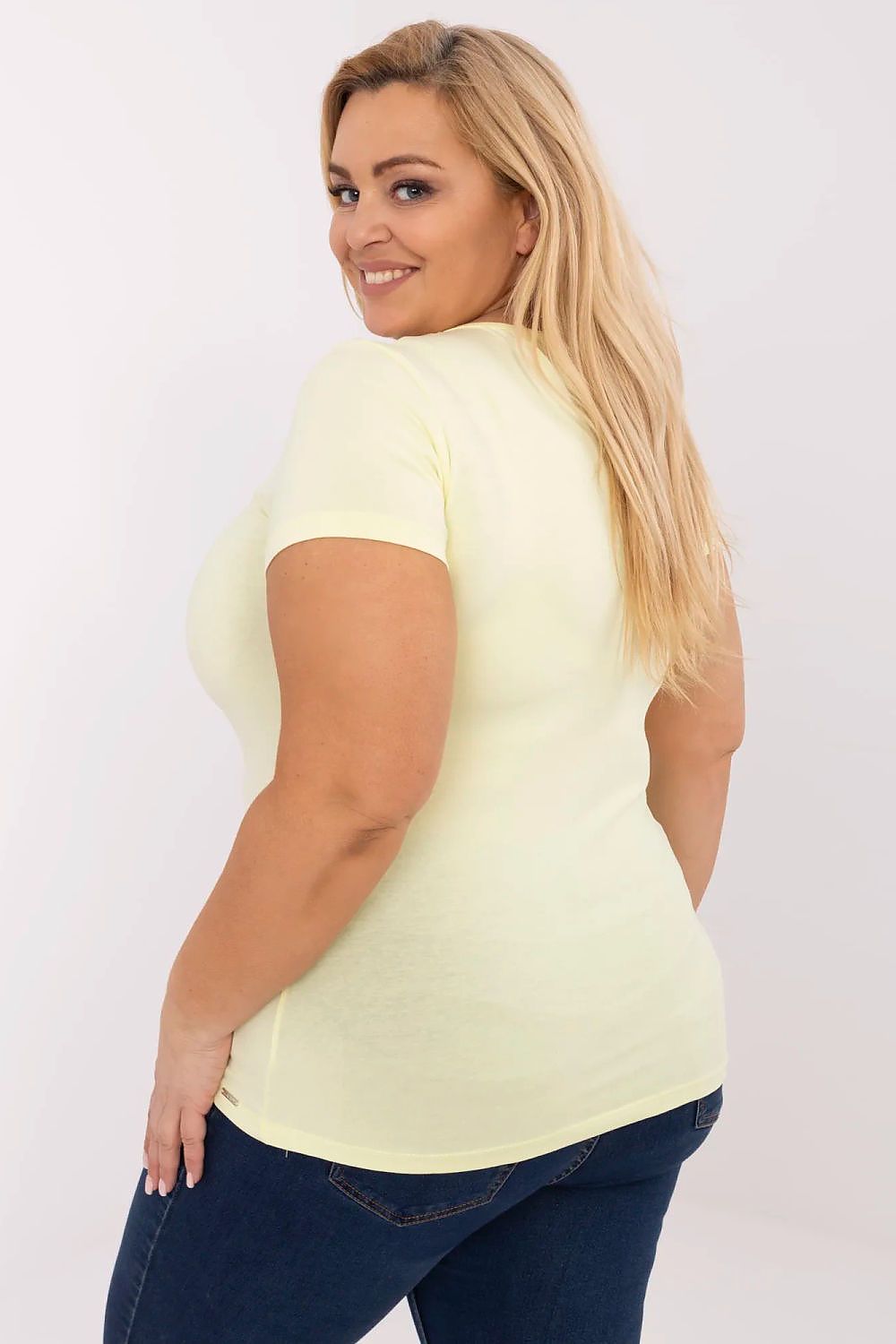 Woman wearing Elvarra Plus Size Cotton Tee in pastel color, showing back view with short sleeves and round neckline for daily style.