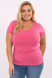 Woman wearing Elvarra Plus Size Cotton Tee in pink, featuring short sleeves and round neckline for everyday style.