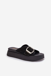 Solva suede platform slides with bold front buckle, featuring soft suede texture and cushioned insole for comfort and style.