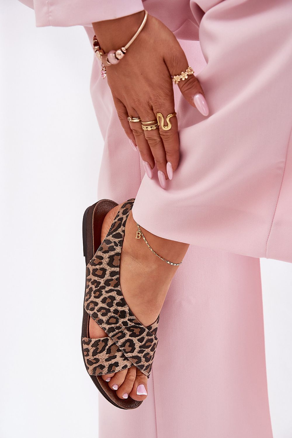 Woman in pink pants wearing Talmea Soft-Strap Leopard Print Leather Sandals, showing minimal silhouette and luxury design.