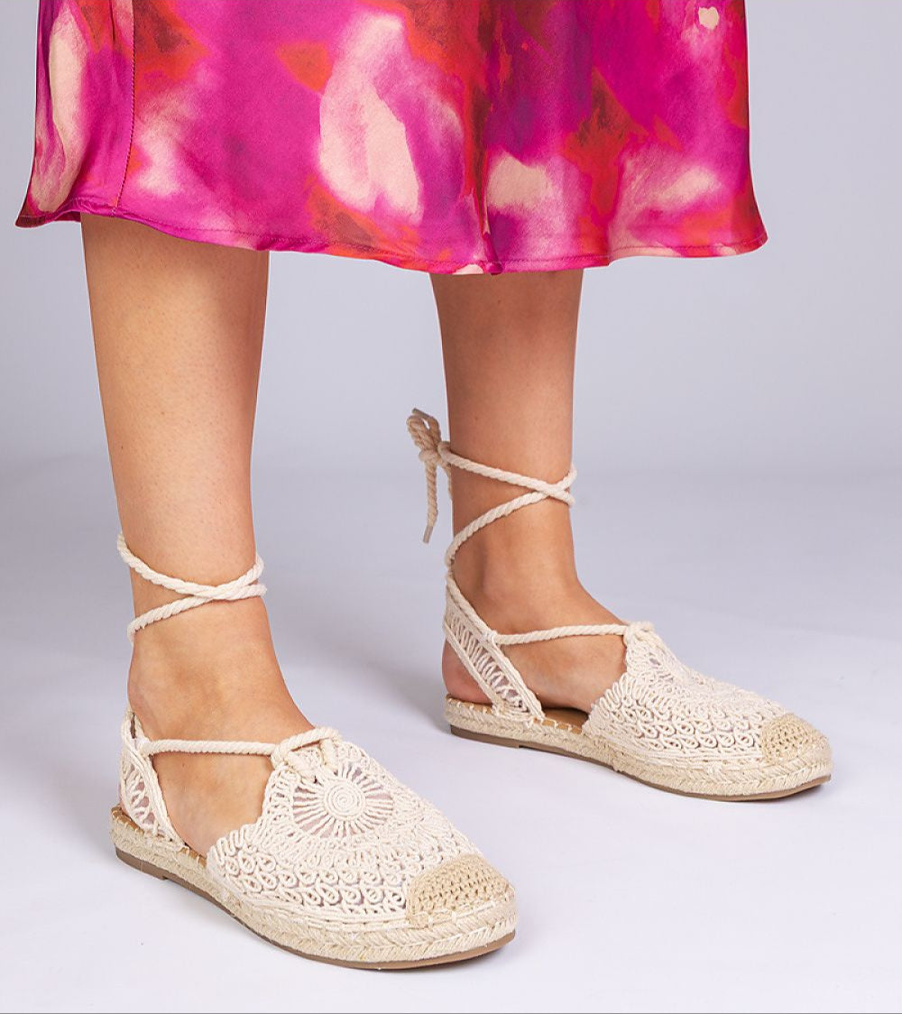 Woman wearing Serella Espadrille Sandals with braided jute-effect sole and colorful dress
