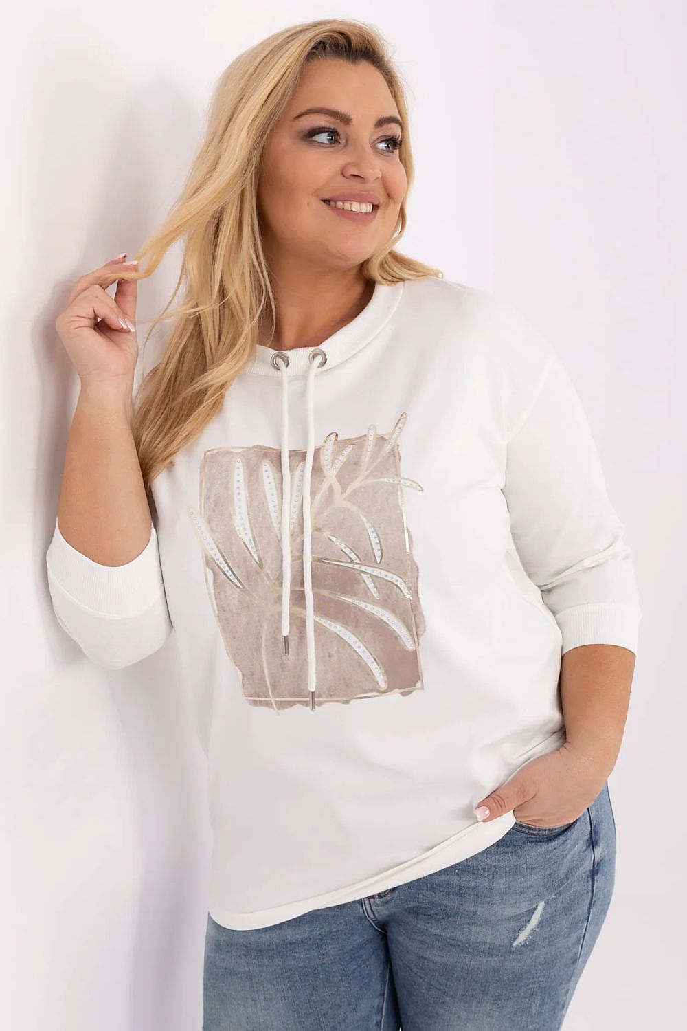Plus size cotton tie blouse with 3/4 sleeves, round neckline, and front print with sequins, worn by a model.