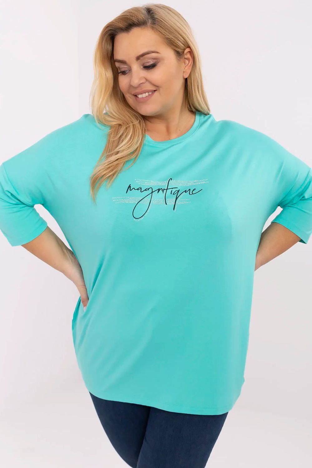 Alt Tag: Plus size model wearing Lioraelle printed jet blouse with 3/4 sleeves and front inscription, casual chic style.