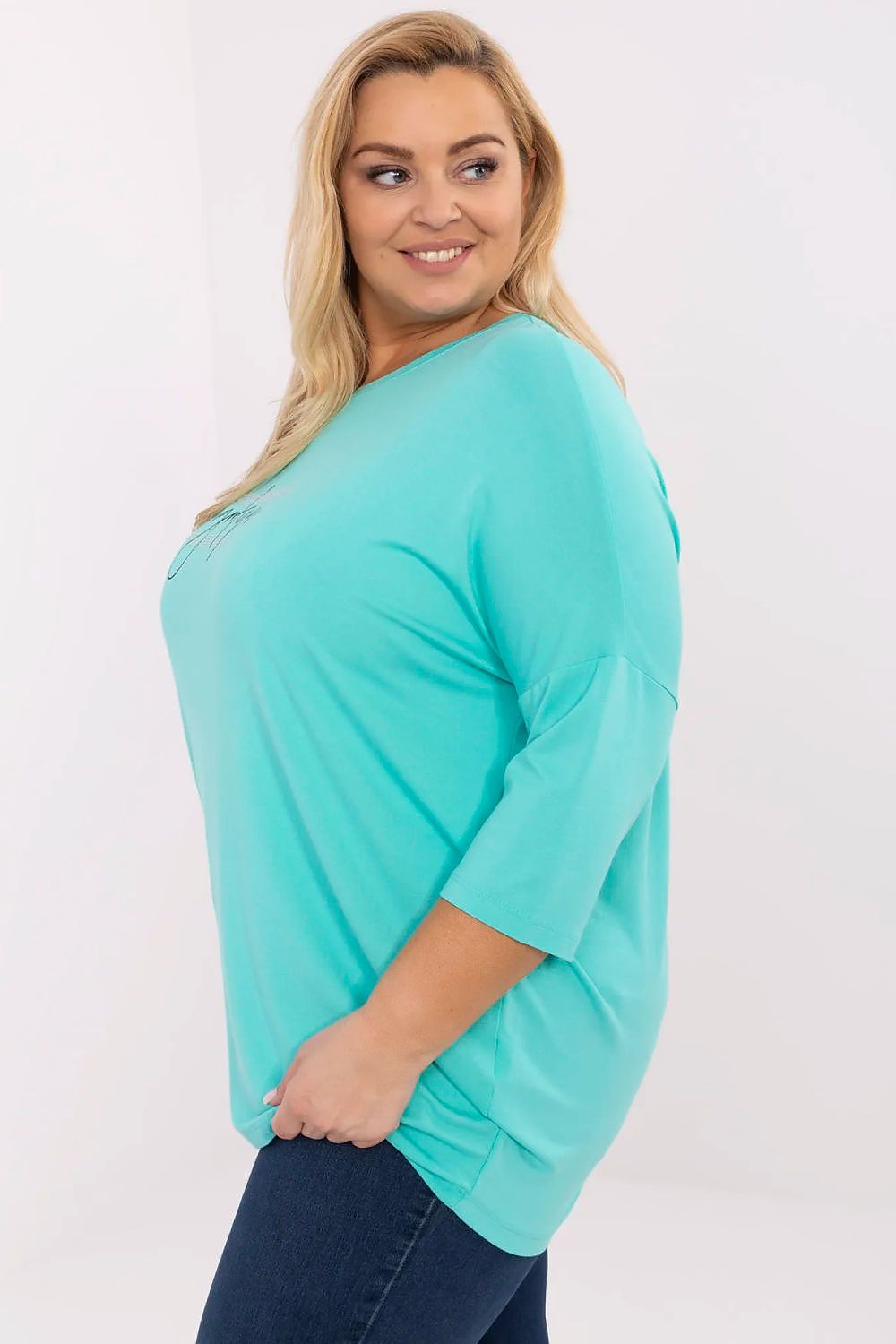 Model wearing Lioraelle plus size turquoise printed jet blouse with 3/4 sleeves and casual round neckline.