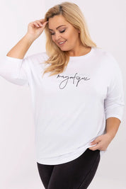 Plus size model wearing Lioraelle printed jet blouse with 3/4 sleeves, white color, featuring elegant script and casual look.