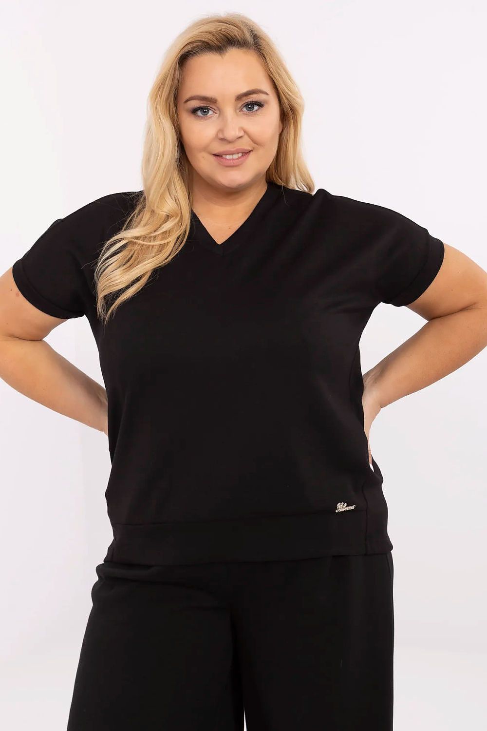 Plus size V-neck blouse in black, shown on model with short sleeves, designed for comfort and elegance, perfect for layering.