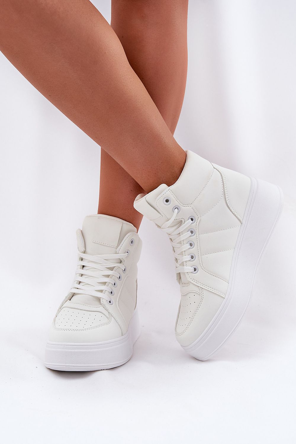 Woman wearing Cavora Platform High-Top Sneakers in smooth eco leather with 4 cm platform, showcasing sleek, modern design and secure fit.