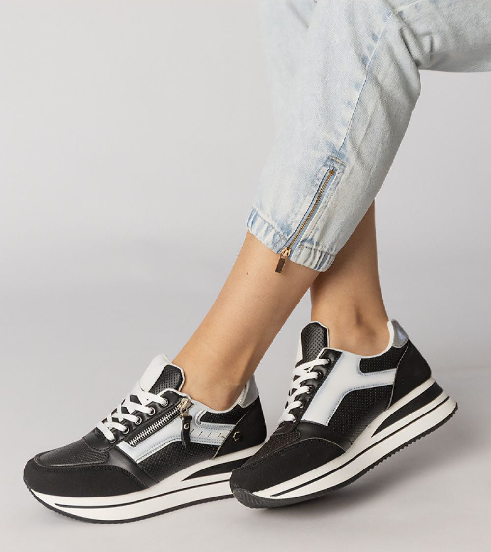 Vorelle Zip-Up Sneakers in black with decorative side zipper, synthetic leather, platform sole, and textile interior for casual comfort.