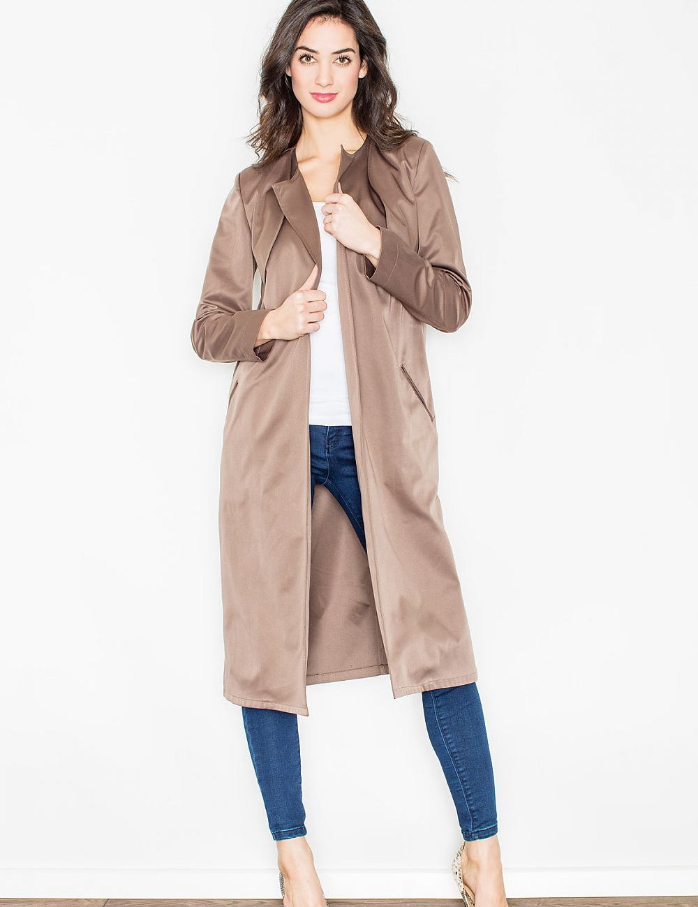 Woman wearing Selvarra Belted Knit Long Coat, taupe, open front, standing indoors, styled with jeans and heels.
