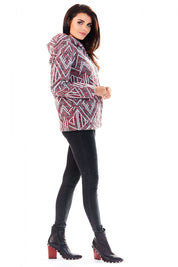 Woman wearing Marquetta Patterned Hooded Jacket with geometric design, mid-weight fabric, full-length zip and side pockets, styled with boots.