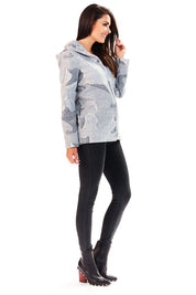 Side view of a woman wearing the Marquetta Patterned Hooded Jacket, showcasing its relaxed fit, subtle pattern, and practical hood.