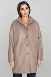 Woman wearing Norivelle kimono-style lined coat with stand-up collar and button fastening, showcasing elegant design and relaxed fit.