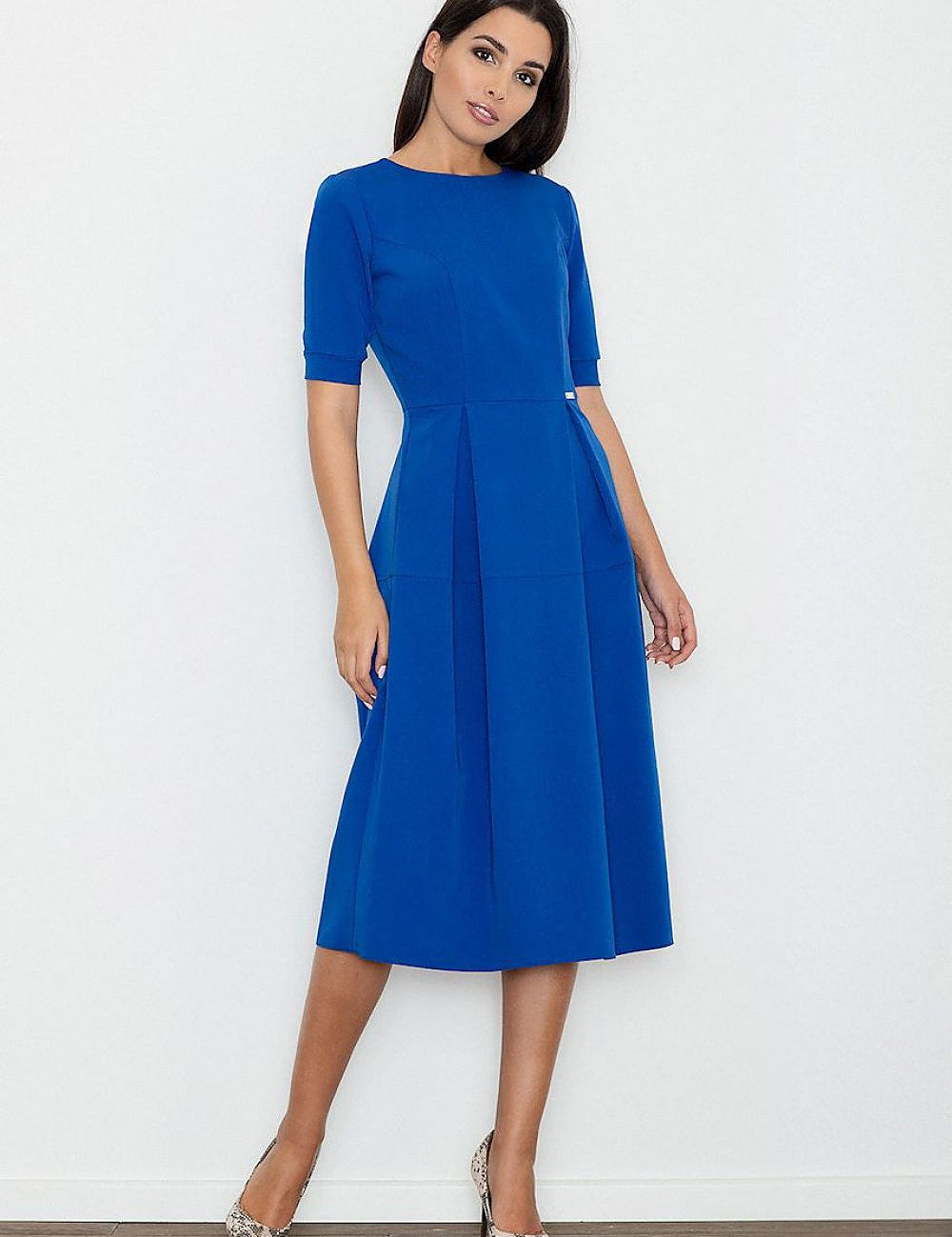 Model wearing Calista cotton pleated daydress in blue, showcasing a fitted bodice and elegant long hemline.