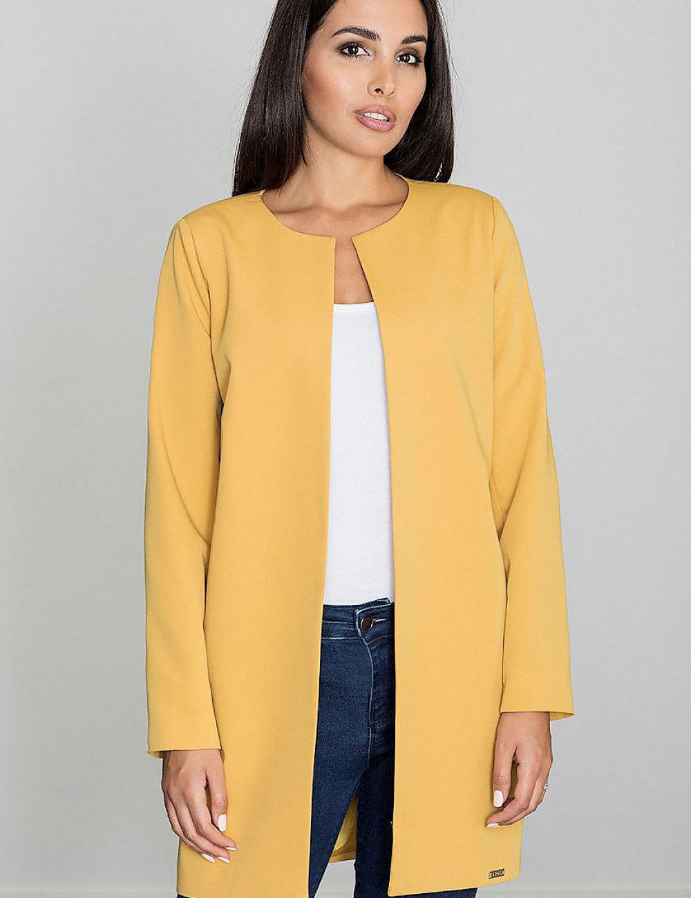 Woman wearing Alverine viscose-blend lightweight coat in yellow, showcasing a straight, minimalist design over casual jeans and top.
