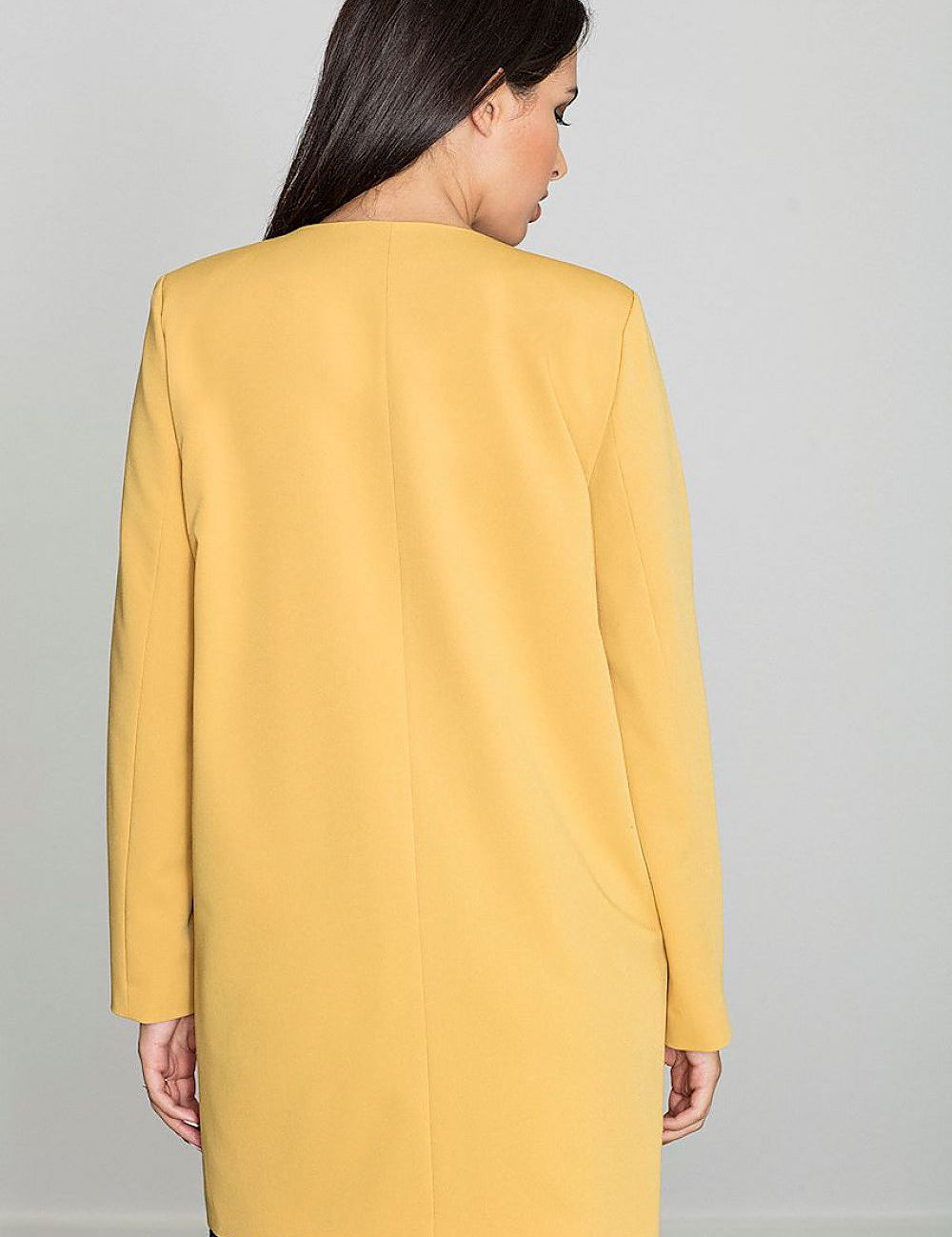 Back view of woman wearing Alverine lightweight viscose-blend coat in yellow, showcasing straight cut and minimalist design.