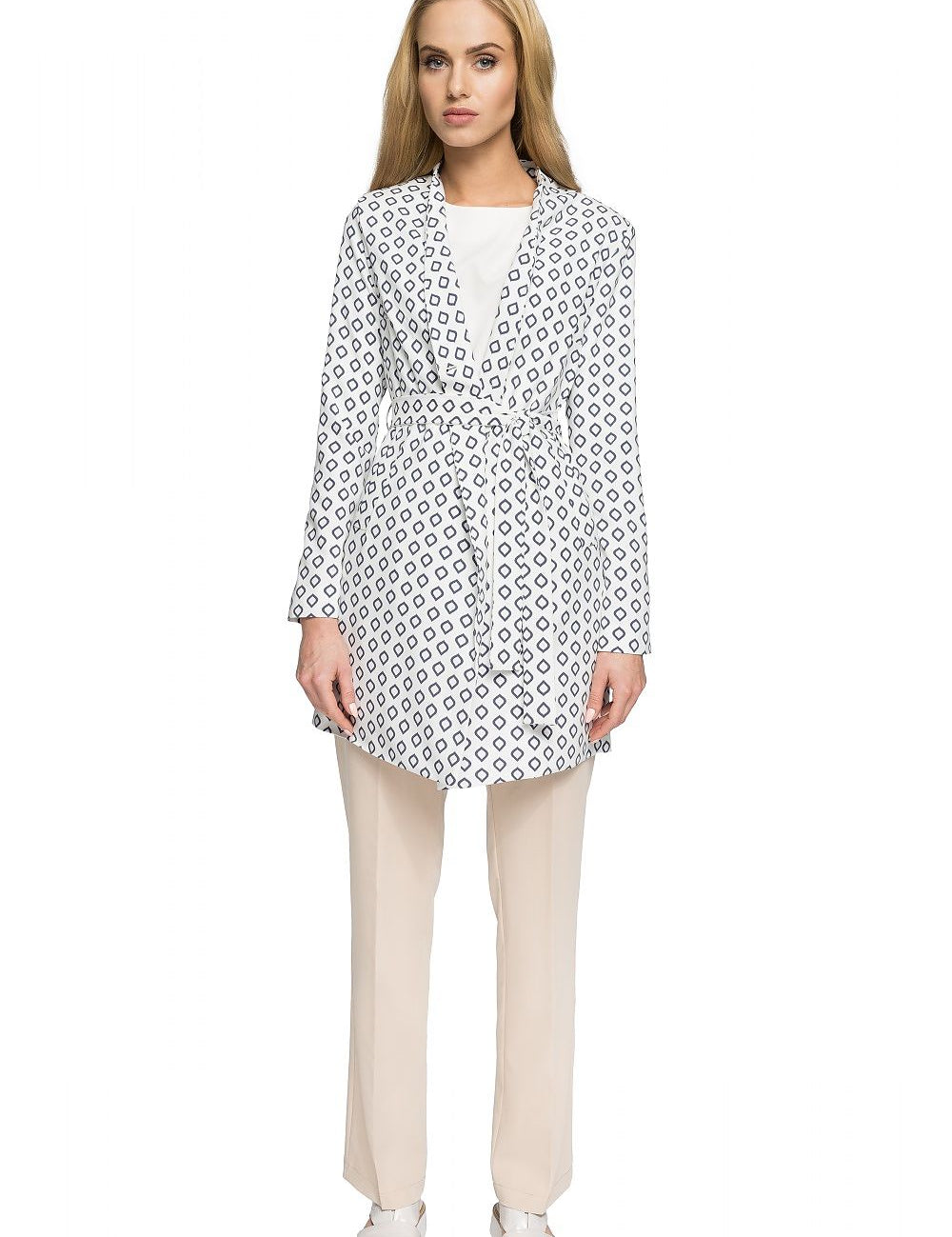 Woman wearing Orvianne Printed Belted Midi Coat with patterned design, belted waist, shown over beige trousers, highlighting feminine style.