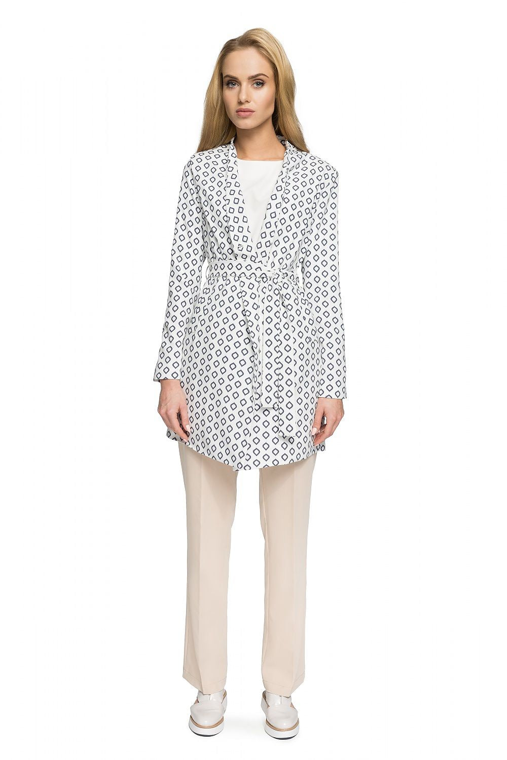 Woman wearing Orvianne Printed Belted Midi Coat with patterned design, belted waist, shown over beige trousers, highlighting feminine style.