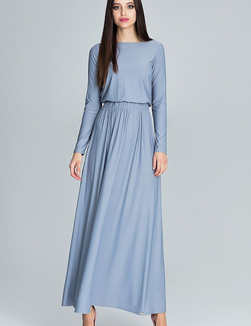 Woman wearing a Naleira Soft Drape Maxi Dress in blue, showcasing a long-sleeve design and elegant silhouette. Perfect for versatile styling.