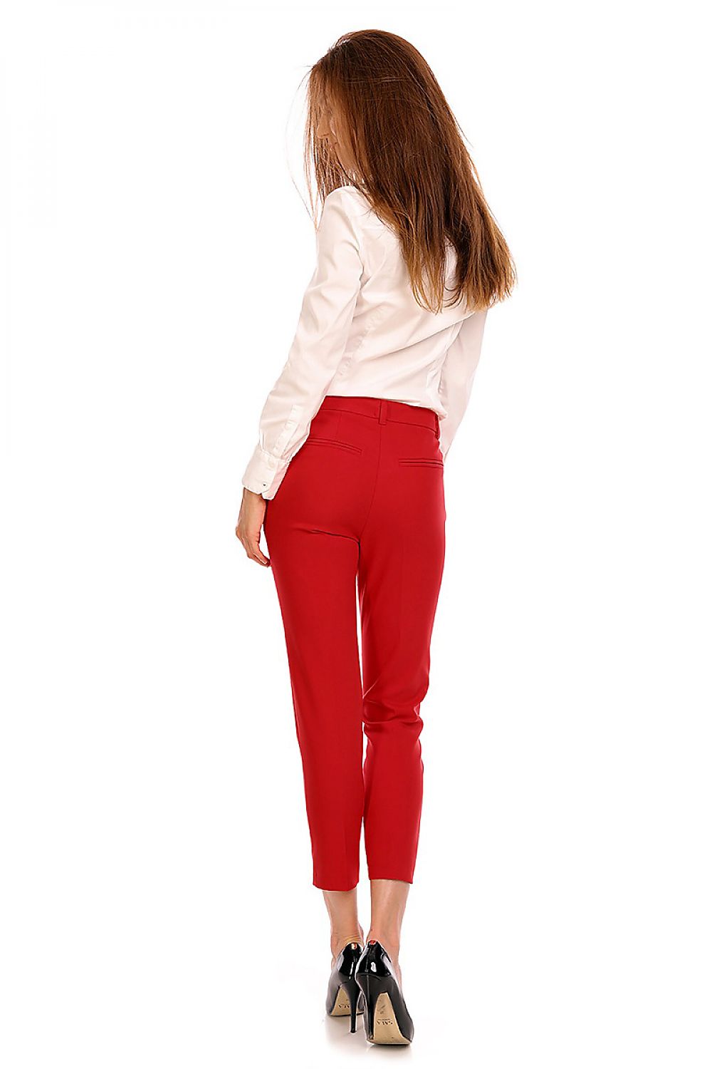 Back view of woman wearing red plus size Marvielle high-waist 7/8 trousers with tailored cut and stylish design.