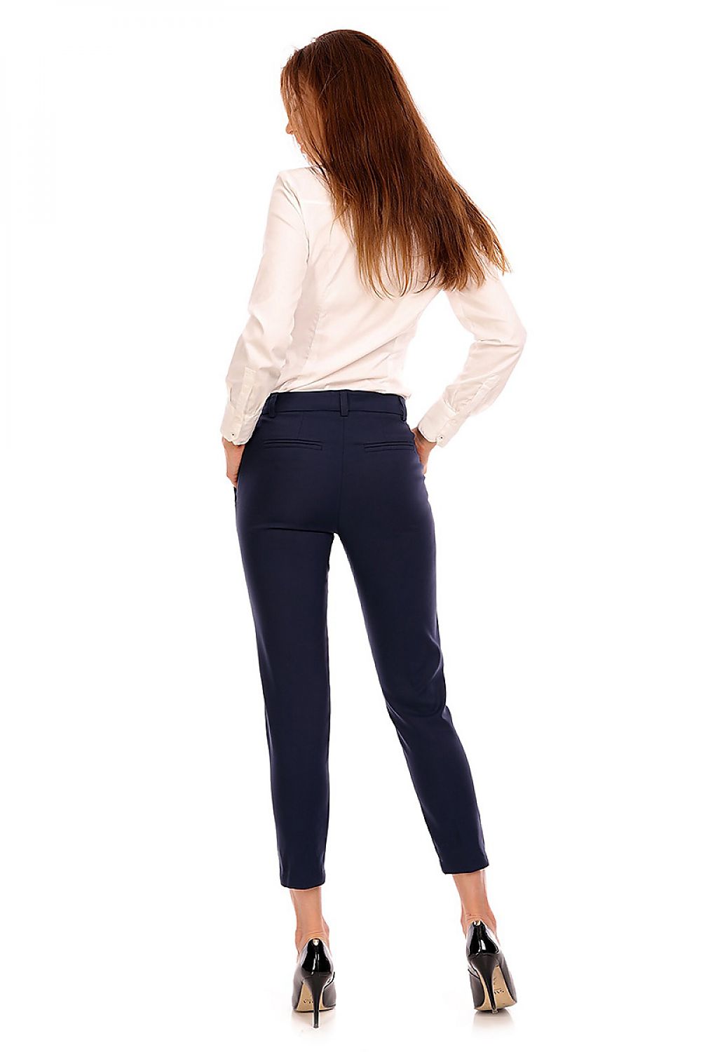 Woman in plus size high-waist 7/8 trousers and white blouse, showcasing elegant formal wear with tailored fit.