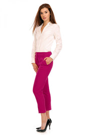 Woman wearing elegant plus size Marvielle High-Waist 7/8 Trousers in magenta, styled with a white blouse and black heels.