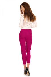 Woman wearing pink high-waist 7/8 trousers with a tailored fit, perfect for plus size office or casual outfits, side view