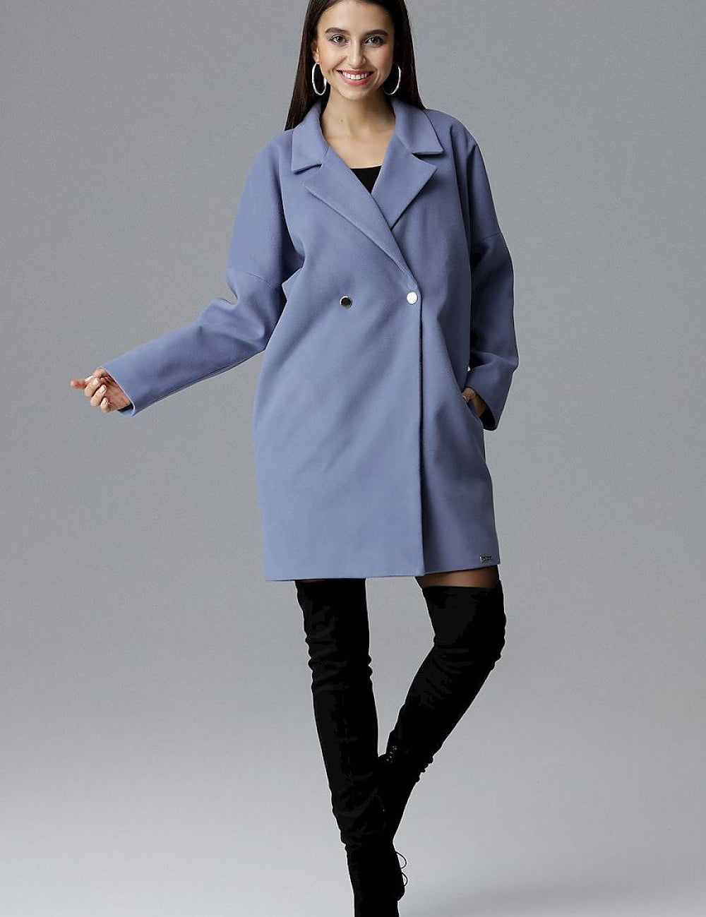 Model wearing Calverra Loose-Fit Coat with Kimono Sleeves, double-breasted design, modern blue color, stylish and versatile.