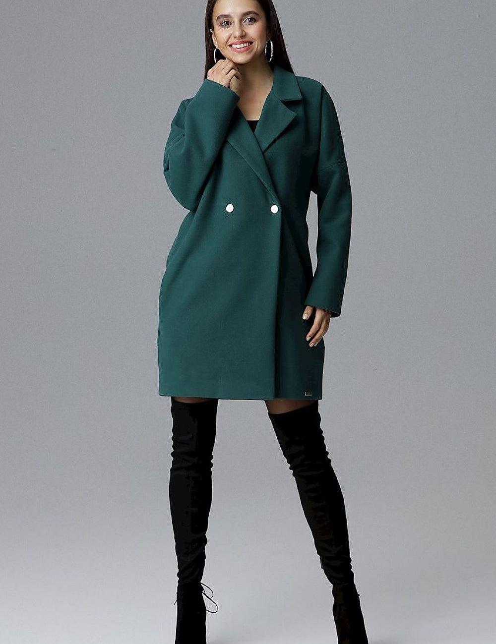 Model wearing Calverra Loose-Fit Coat with kimono sleeves and decorative buttons, showcasing a blend of comfort and sophistication.
