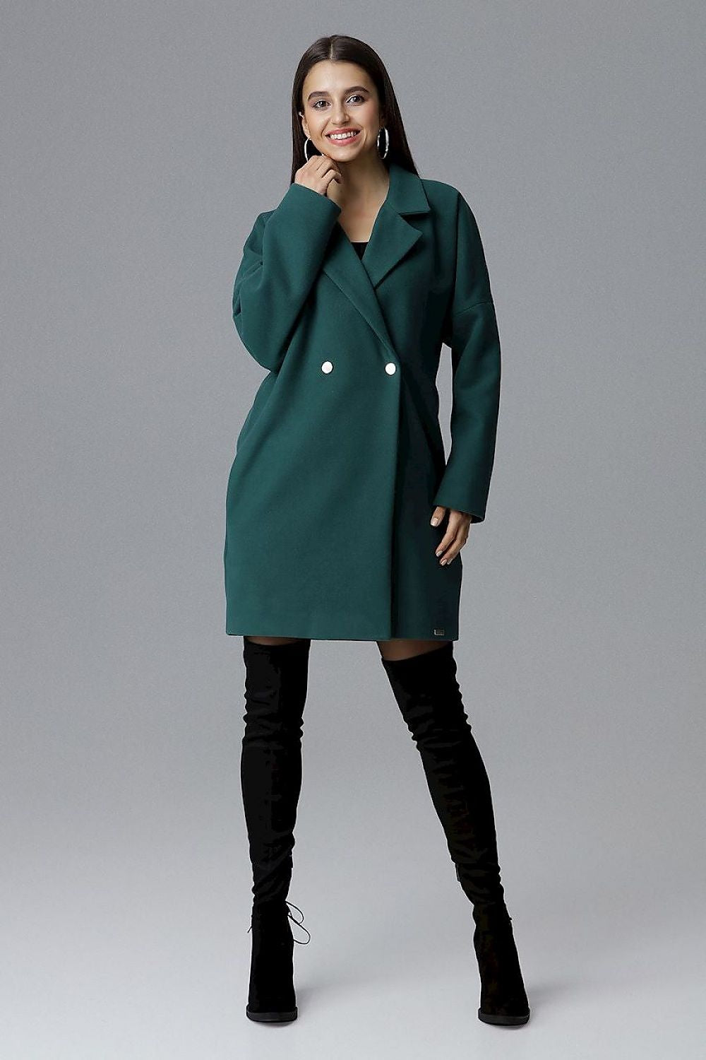 Model wearing Calverra Loose-Fit Coat with kimono sleeves and decorative buttons, showcasing a blend of comfort and sophistication.