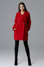 Model wearing Calverra loose-fit coat with kimono sleeves in red, showcasing its double-breasted design and elegant style.