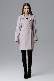 Woman wearing Calverra loose-fit coat with kimono sleeves, double-breasted design, in elegant fabric, perfect for casual or refined outfits.