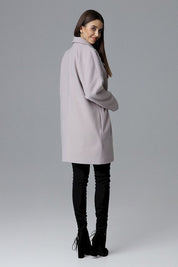 Model wearing a Calverra loose-fit coat with kimono sleeves from the back, double-breasted design, in a soft color, against a gray background.