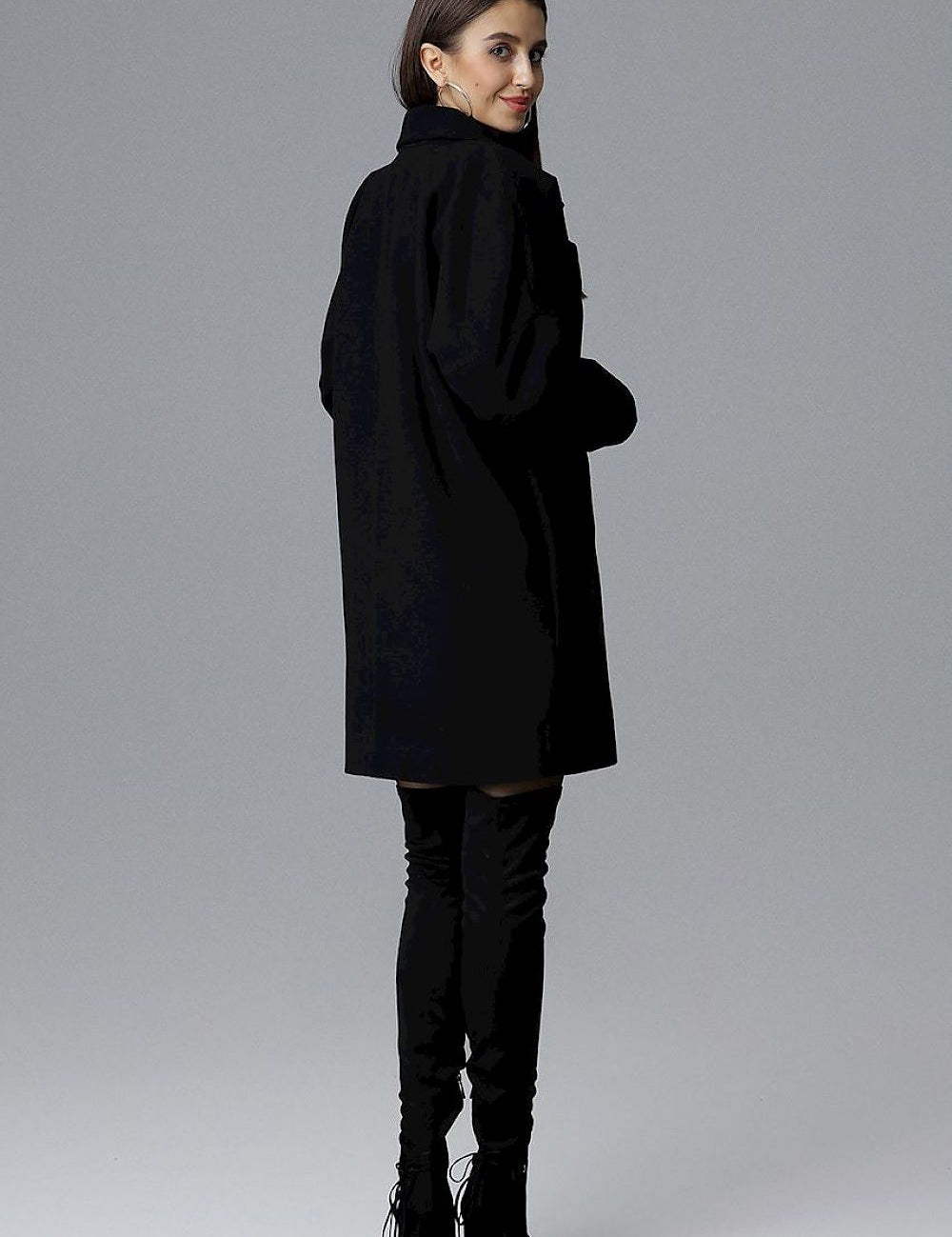 Model wearing Calverra loose-fit coat with kimono sleeves, double-breasted design, decorative buttons, and functional pockets, back view.
