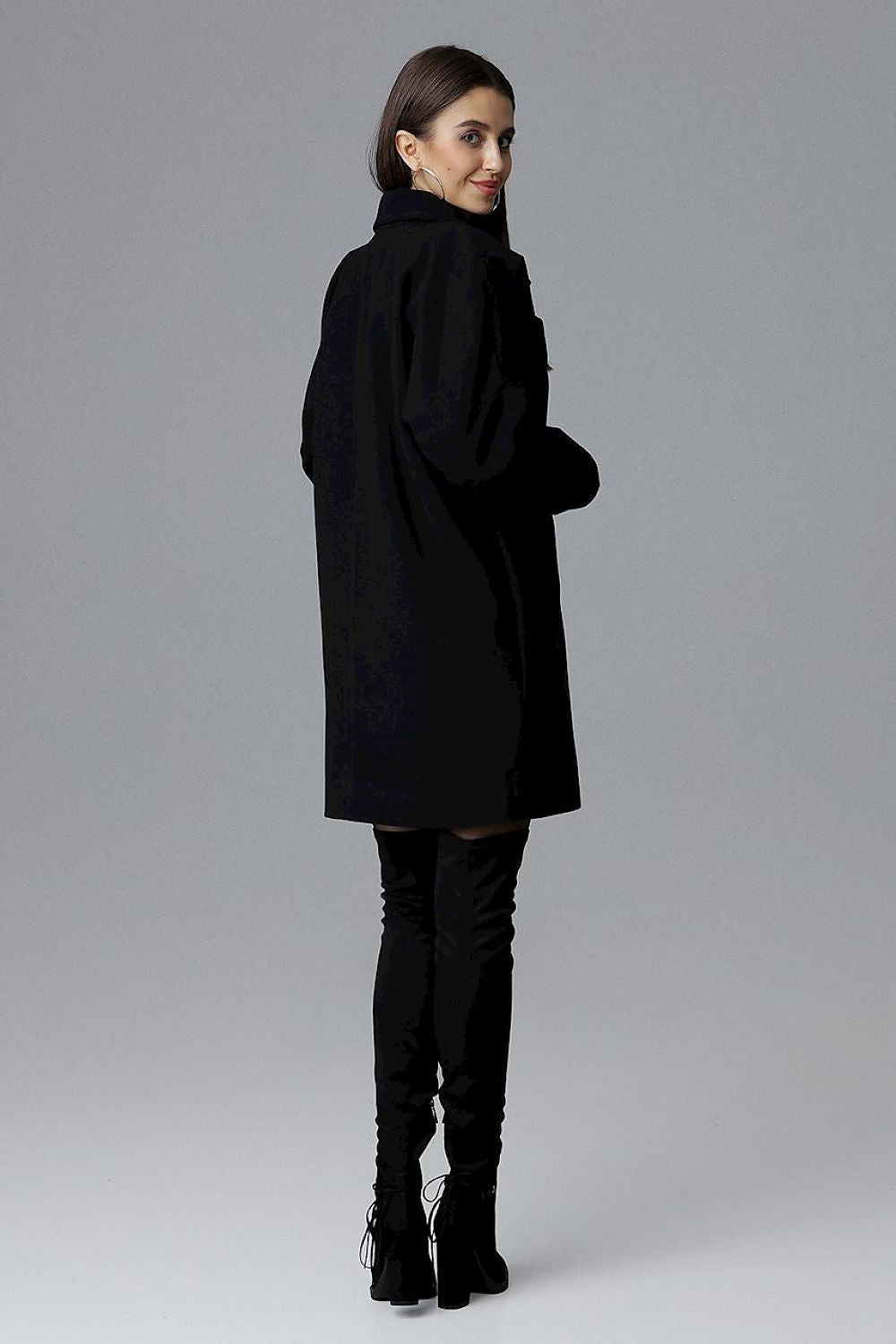 Model wearing Calverra loose-fit coat with kimono sleeves, double-breasted design, decorative buttons, and functional pockets, back view.