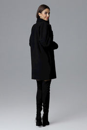 Model wearing Calverra loose-fit coat with kimono sleeves, double-breasted design, decorative buttons, and functional pockets, back view.