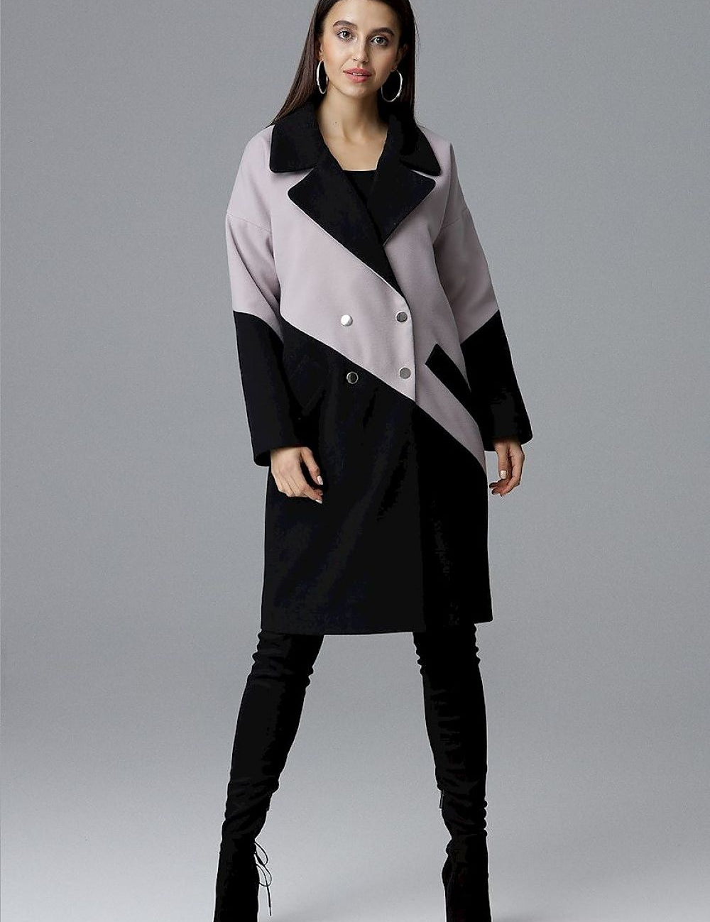 Model wearing Ornavine two-tone coat with turn-up collar and silver snap fasteners, showcasing elegance and modern style.