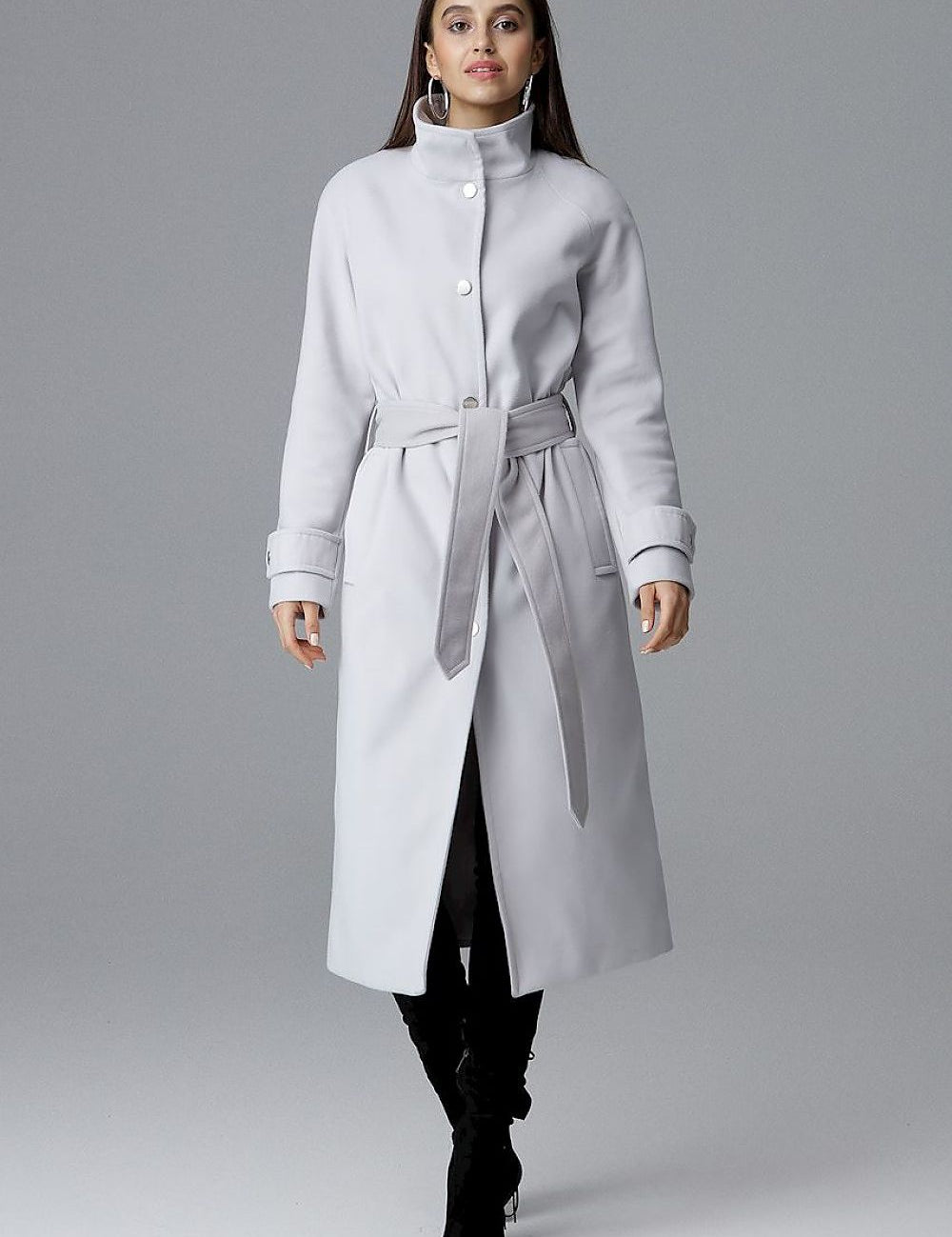 Woman wearing Melvarine Long Single-Breasted Belted Coat with button closure and waist belt, showcasing elegant, timeless design.
