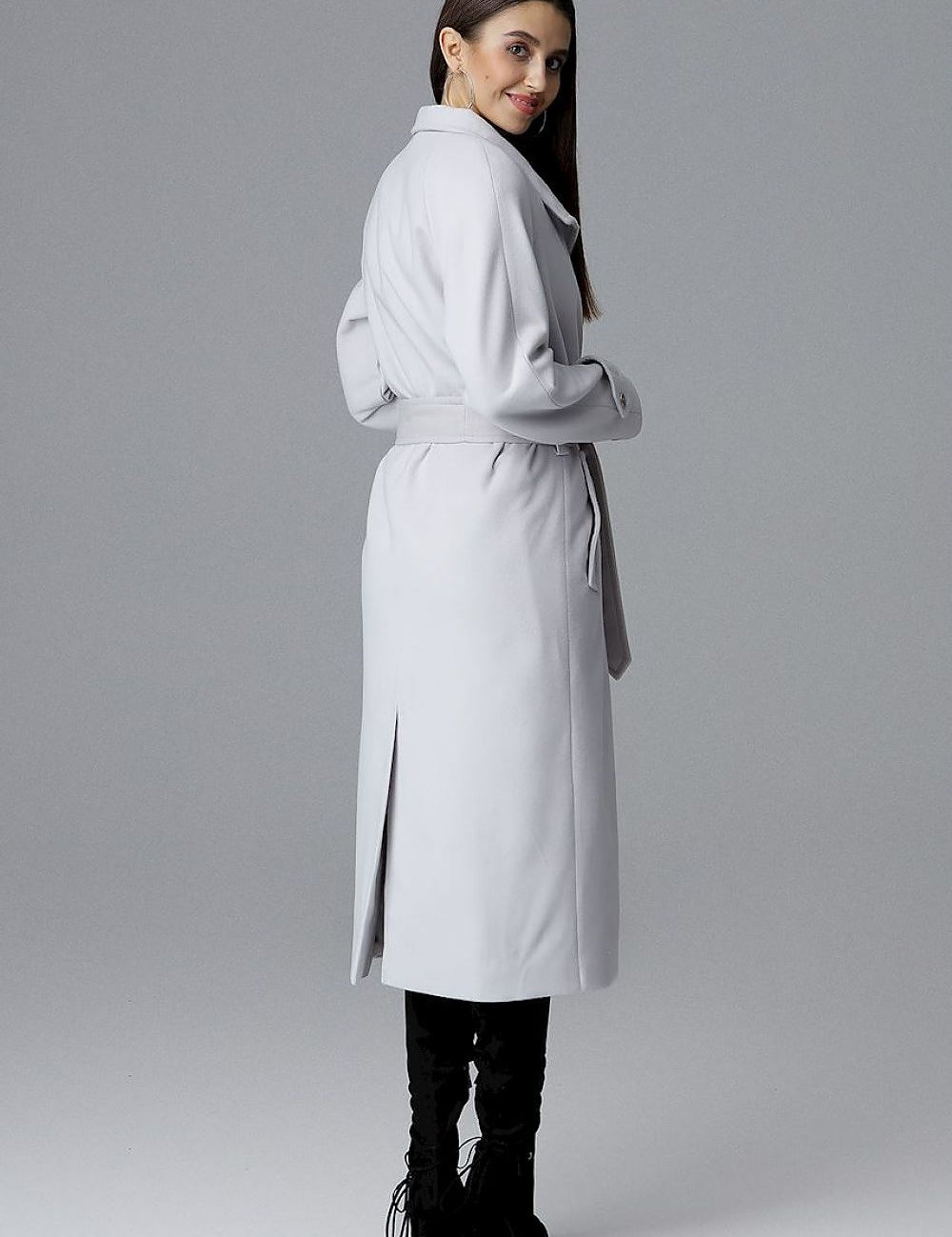 Woman modeling Melvarine Long Single-Breasted Belted Coat with back slit and timeless silhouette for modern style.