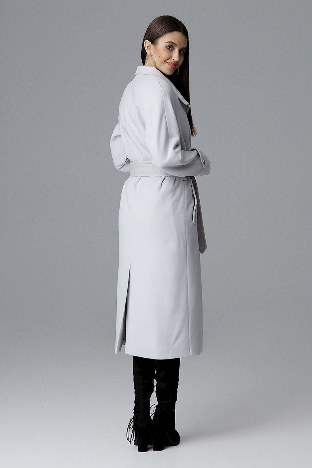 Woman modeling Melvarine Long Single-Breasted Belted Coat with back slit and timeless silhouette for modern style.