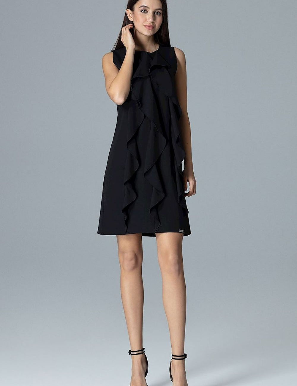 Woman wearing black Elvaree Frill Detail Sleeveless Dress with vertical frills, showing chic and breezy style ideal for sunny days.
