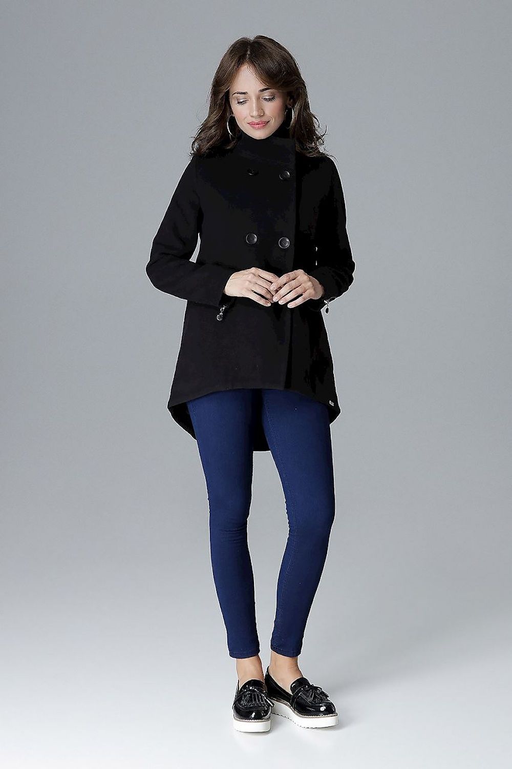 Woman wearing Arvennise stand-collar jacket with zipper details and button placket, styled casually with blue leggings.