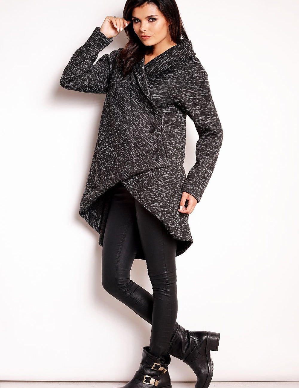 Woman wearing Elvathine loose-fit coat with extended back, styled with black pants and boots.