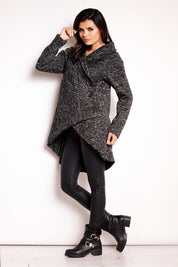 Woman wearing Elvathine loose-fit coat with extended back, styled with black pants and boots.