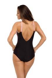 Back view of model wearing plus size black Sorellia one-piece swimsuit with pink adjustable straps