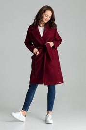 Woman wearing Carivelle Maroon Belted Coat with wide lapels and side pockets, tied at waist, showcasing modern style and elegance.